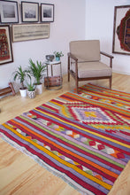 Load image into Gallery viewer, 5x7 Vintage Anatolian Turkish Kilim Area Rug | Strips with vibrant colors and bold medallion | SKU 417